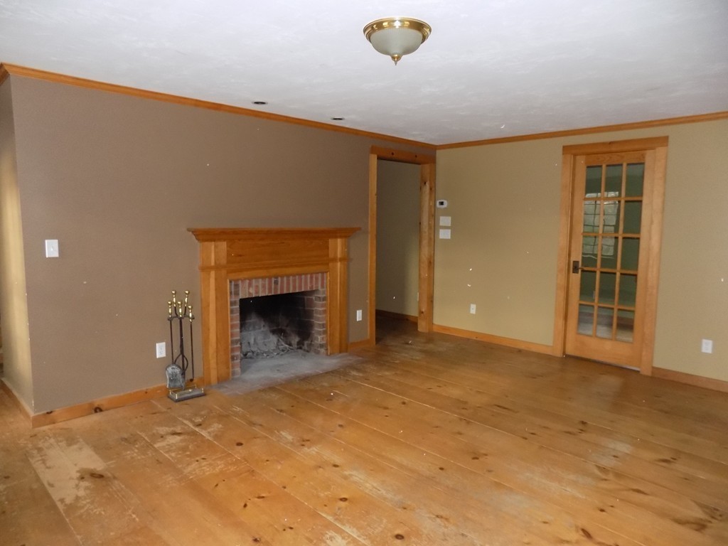 176 Crouch Road Warren, MA 01092 - Photo 7 of 19 a view of an empty room with a fireplace