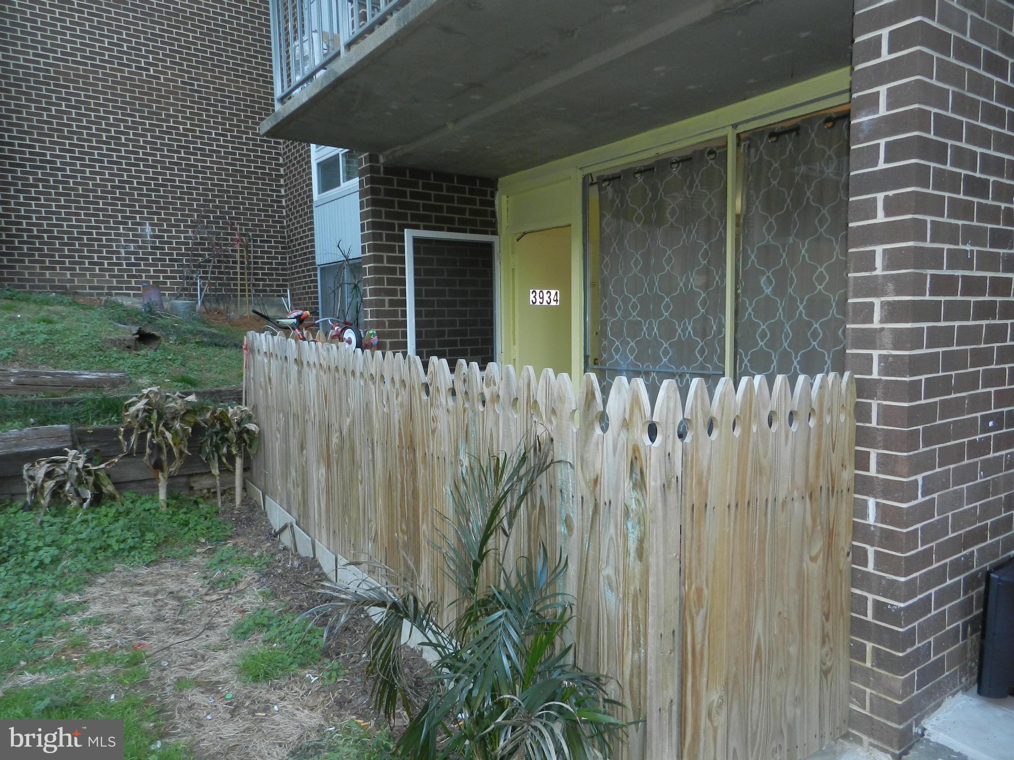 3934 Bel Pre Road, Unit 2 Silver Spring, MD 20906 - Photo 2 of 11 a view of a pathway of a house with backyard and plants