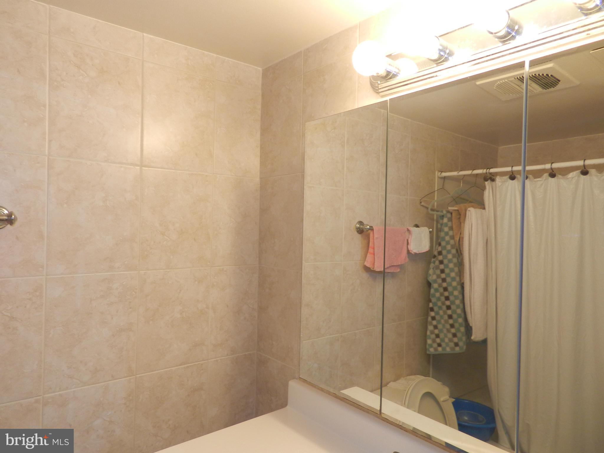 3934 Bel Pre Road, Unit 2 Silver Spring, MD 20906 - Photo 11 of 11 a bathroom with a shower and a toilet