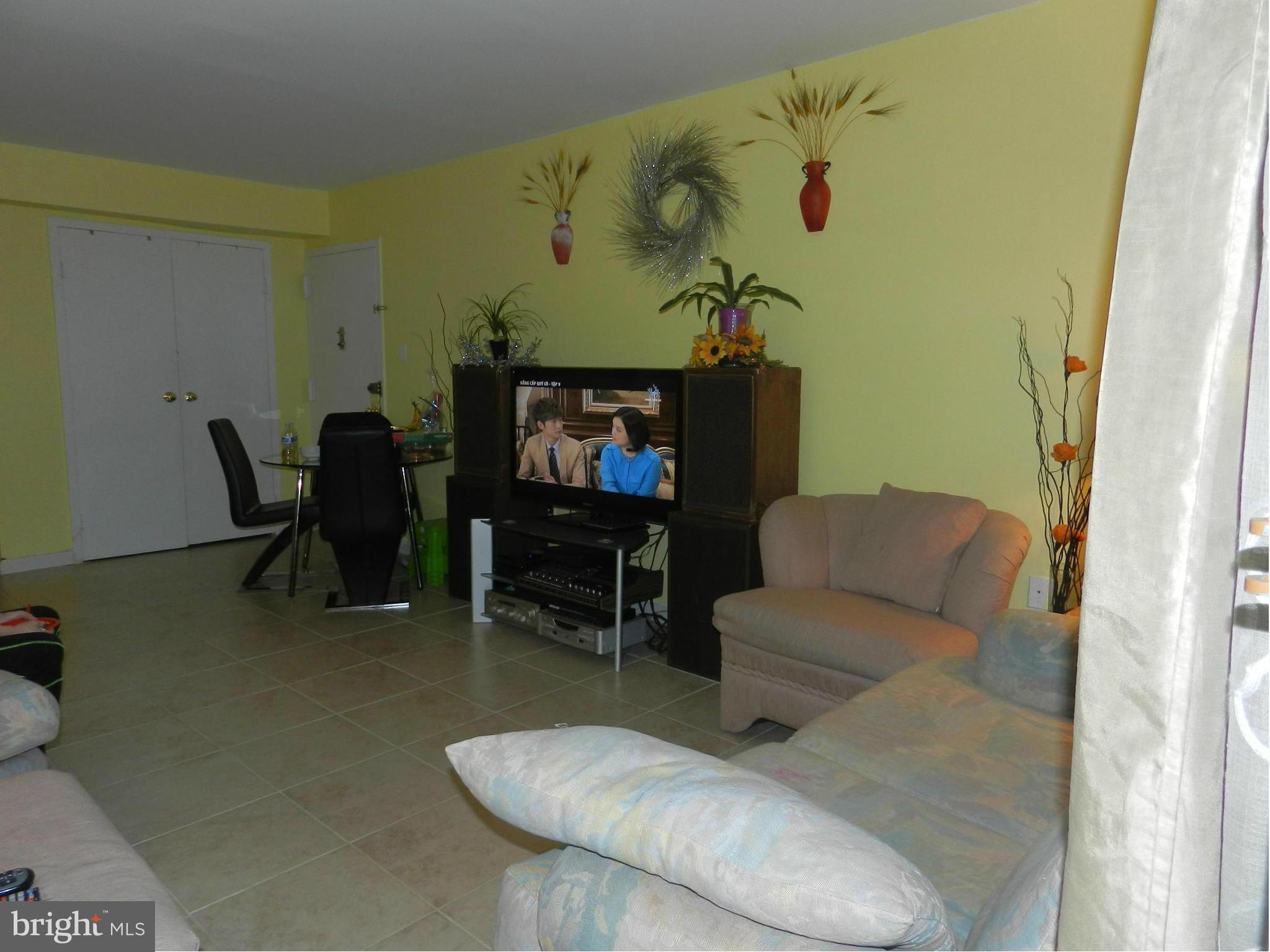 3934 Bel Pre Road, Unit 2 Silver Spring, MD 20906 - Photo 5 of 11 a living room with furniture and a flat screen tv