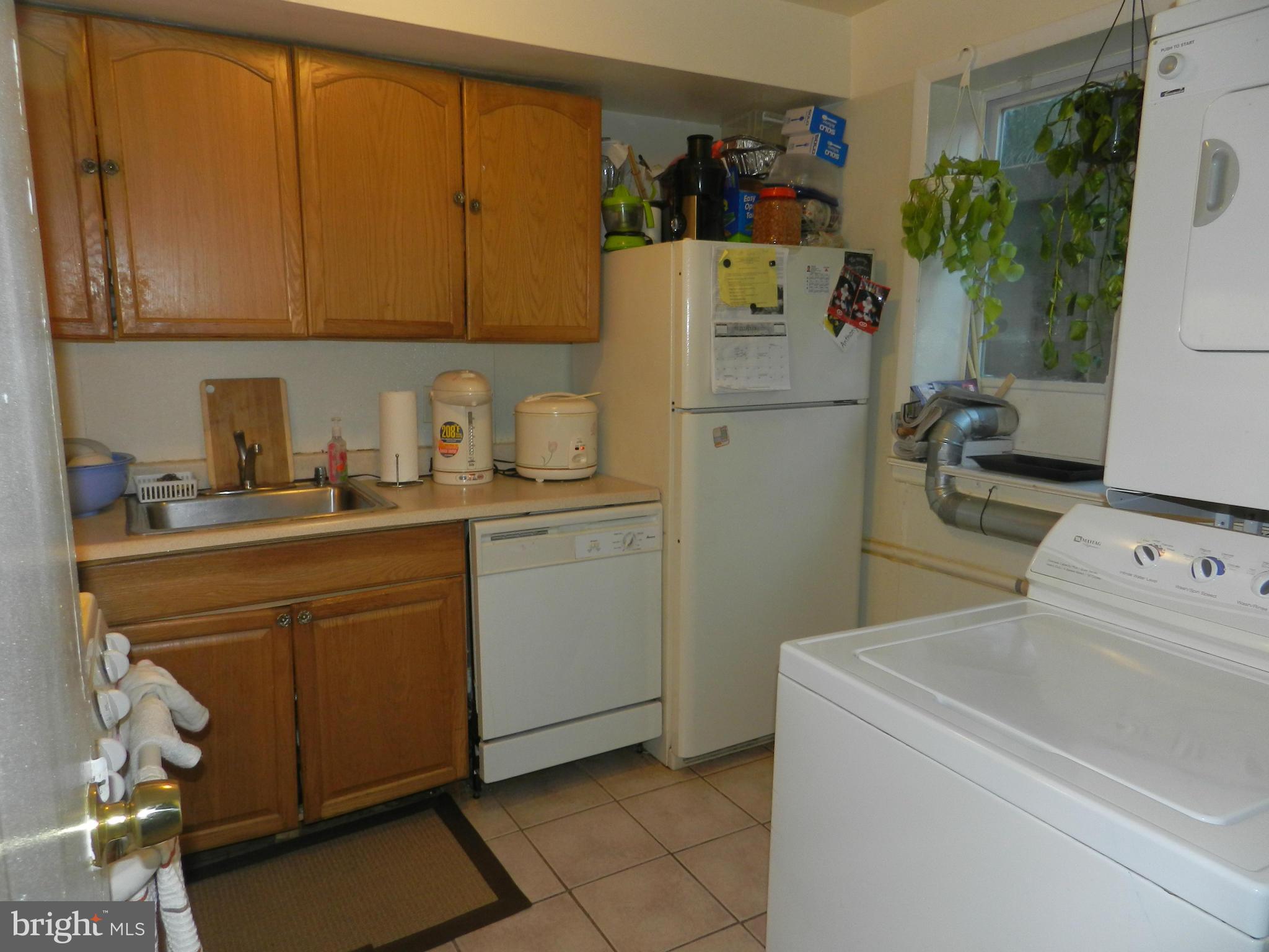3934 Bel Pre Road, Unit 2 Silver Spring, MD 20906 - Photo 6 of 11 a room with a refrigerator and cabinets