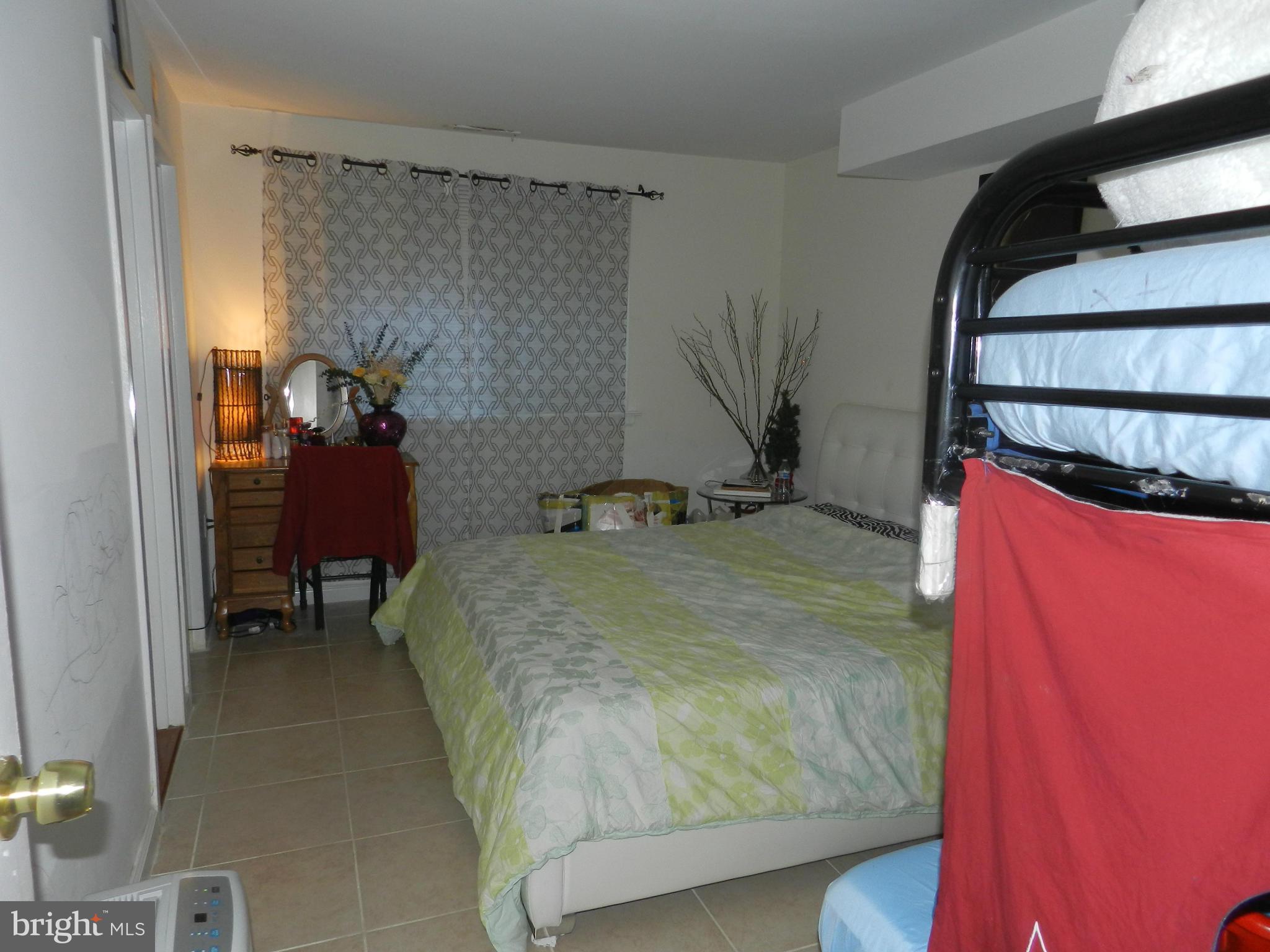 3934 Bel Pre Road, Unit 2 Silver Spring, MD 20906 - Photo 9 of 11 a bedroom with a bed and a mirror