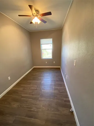 a view of room with window and wooden floor