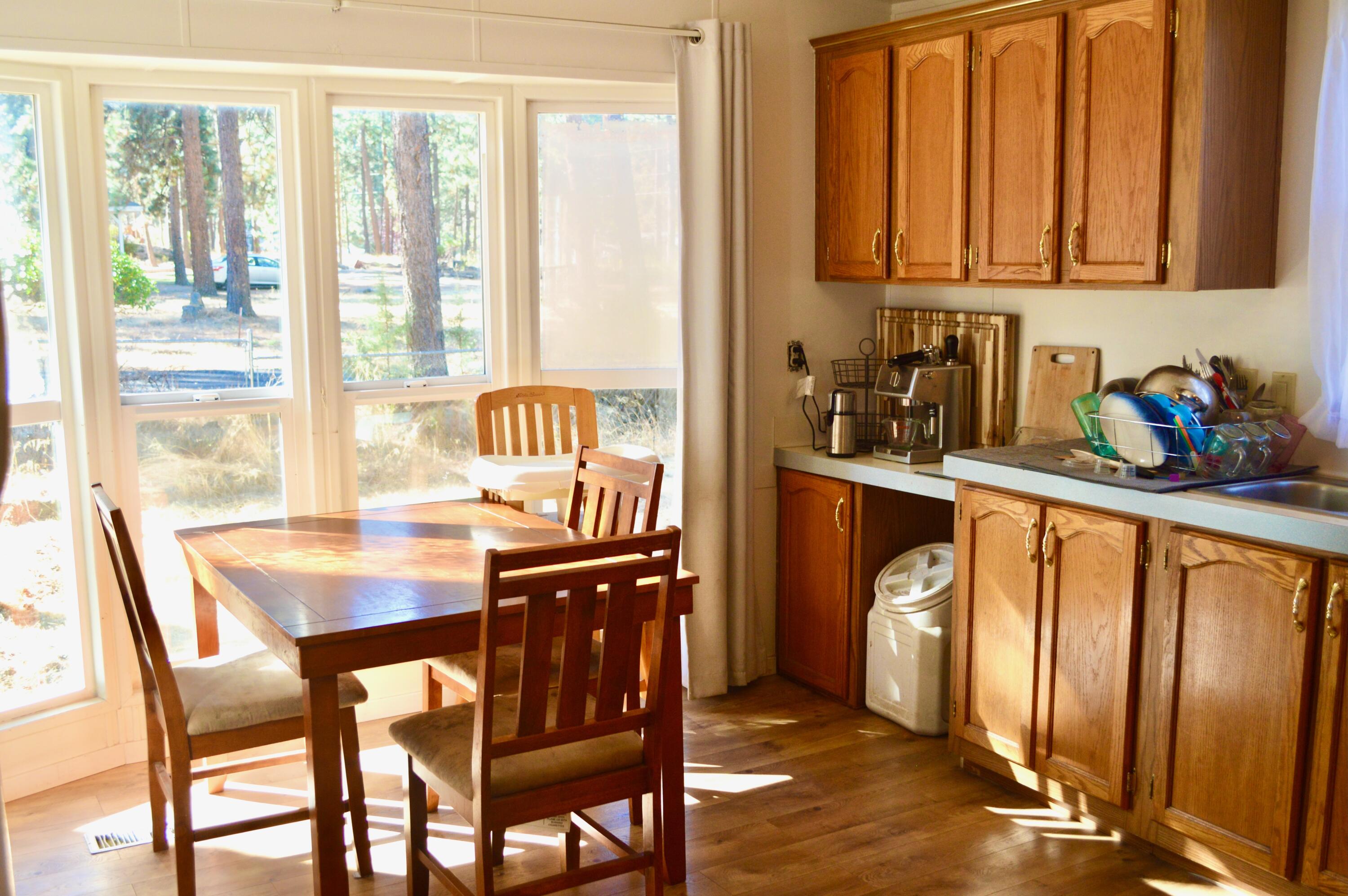 60164 Turquoise Road Bend, OR 97702 - Photo 5 of 21 a dining room with furniture and large windows
