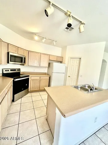 a kitchen with a sink a stove top oven and white kitchen