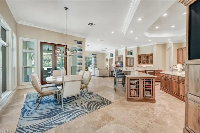 a living room with furniture a large window and chairs