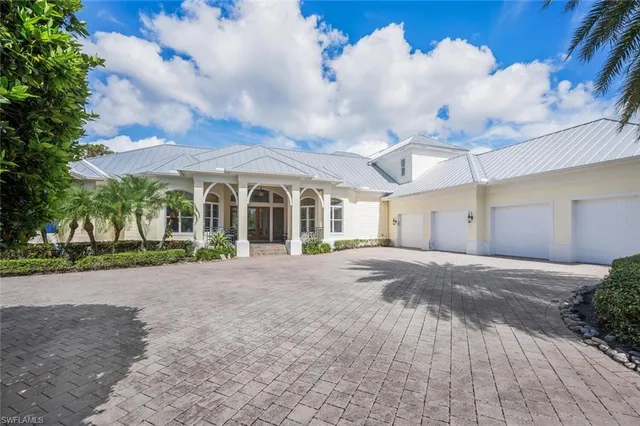 a view of a house with a yard and garage