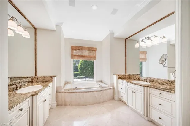 a spacious bathroom with a granite countertop tub sink and mirror