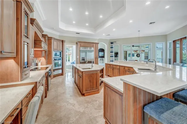a large kitchen with stainless steel appliances kitchen island a large counter top