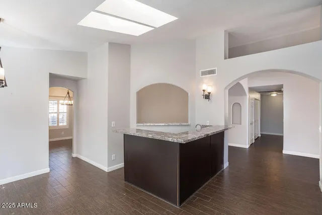 a view of living room with granite countertop furniture and wooden floor