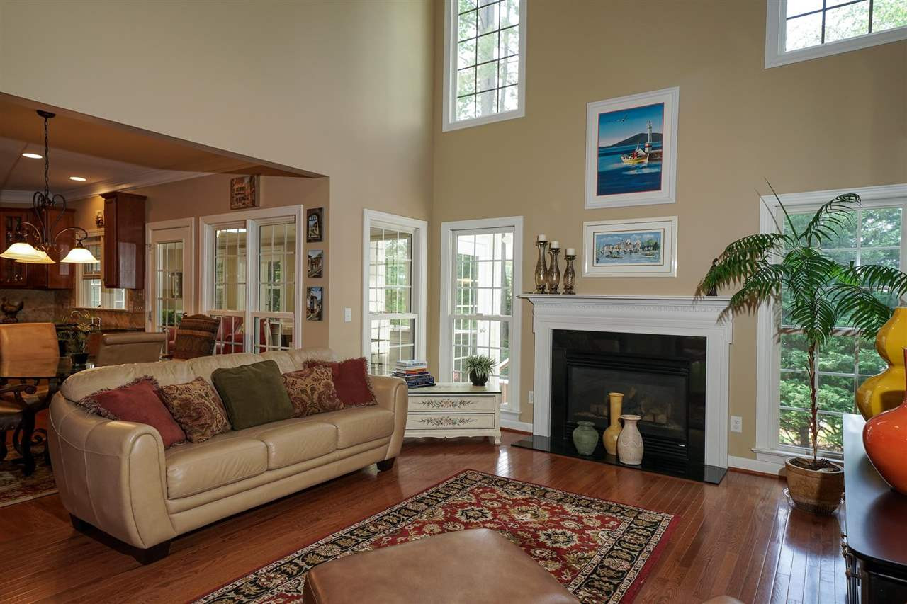 Family Room offers soaring ceilings, beautiful windows and cozy fireplace. Open to the breakfast area and kitchen. Family Room
