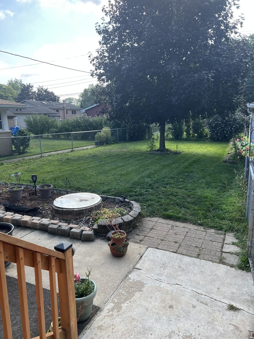 10904 Rutherford Avenue Worth, IL 60482 - Photo 13 of 14 a view of a backyard with plants and outdoor seating