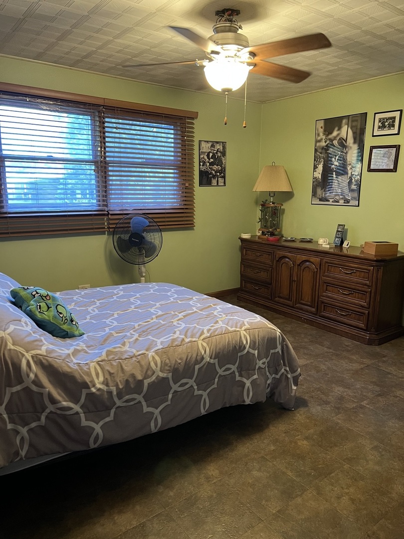 10904 Rutherford Avenue Worth, IL 60482 - Photo 6 of 14 a bed sitting in a bedroom next to a window