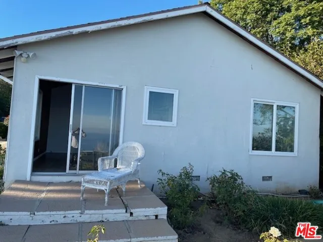 a view of a backyard with potted plants