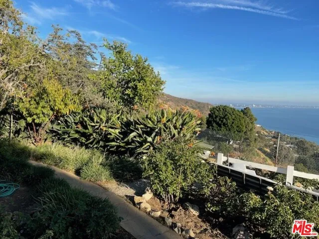 a view of a terrace with lawn chairs