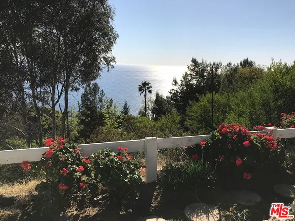 a view of a street with flower garden