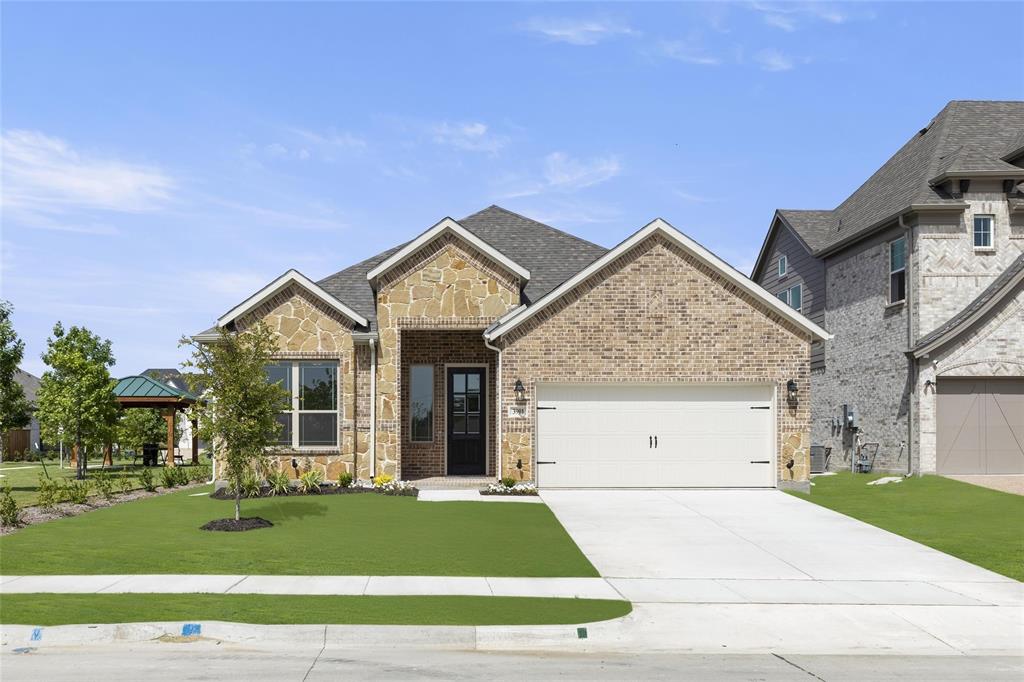 a view of a house with a garden and garage