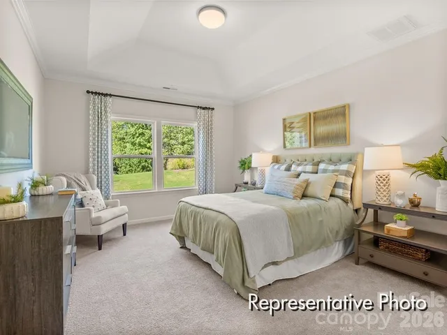 a spacious bedroom with a bed and a couch