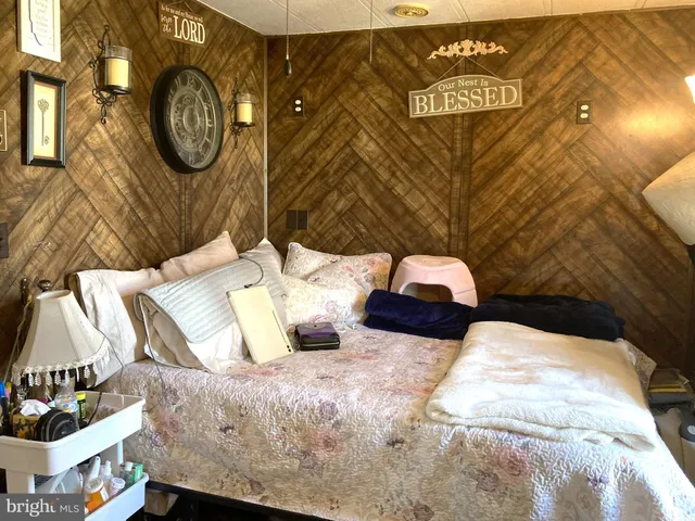 a bedroom with a bed and wall painting on the wall