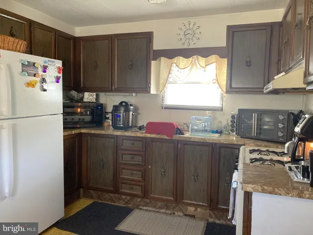 a kitchen with a refrigerator and a sink
