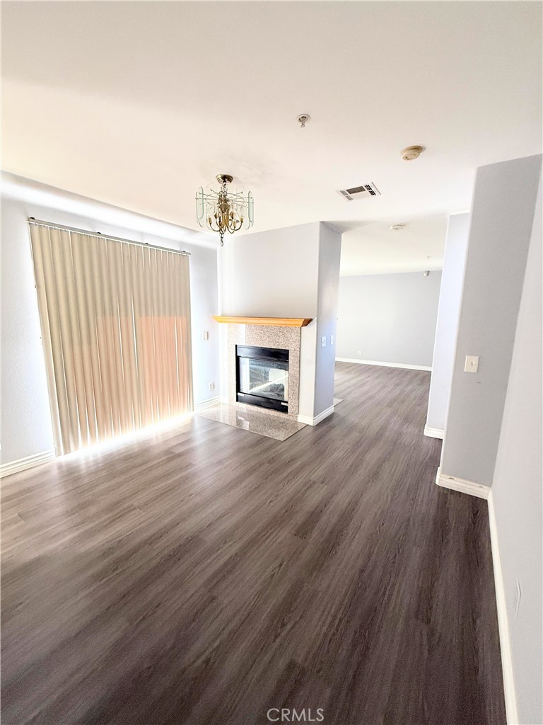 1230 Elm Avenue, Unit G San Gabriel, CA 91775 - Photo 11 of 33 an empty room with wooden floor and fireplace