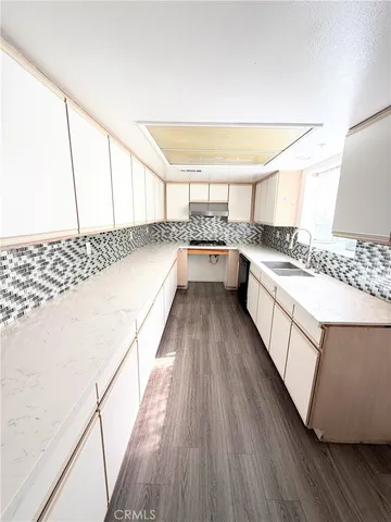 a kitchen with stainless steel appliances granite countertop a sink and a stove