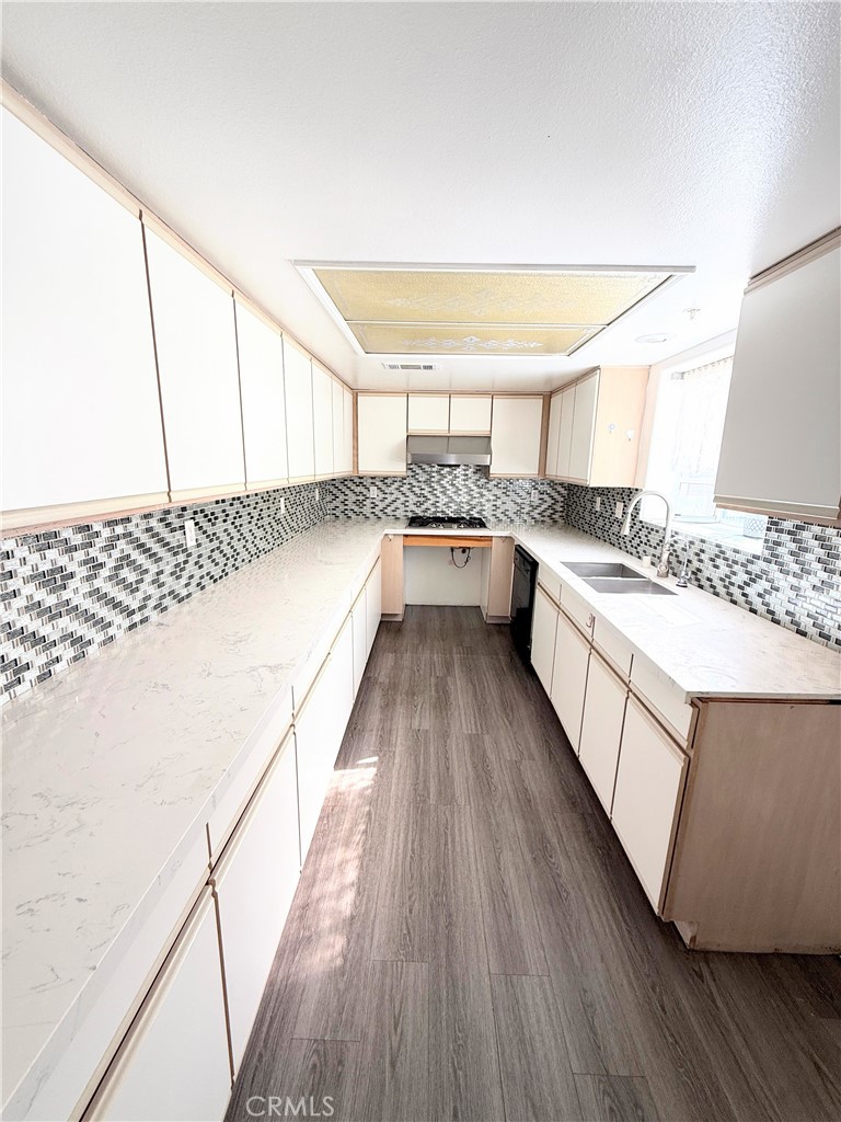 1230 Elm Avenue, Unit G San Gabriel, CA 91775 - Photo 12 of 33 a view of a kitchen with a sink and wooden floor