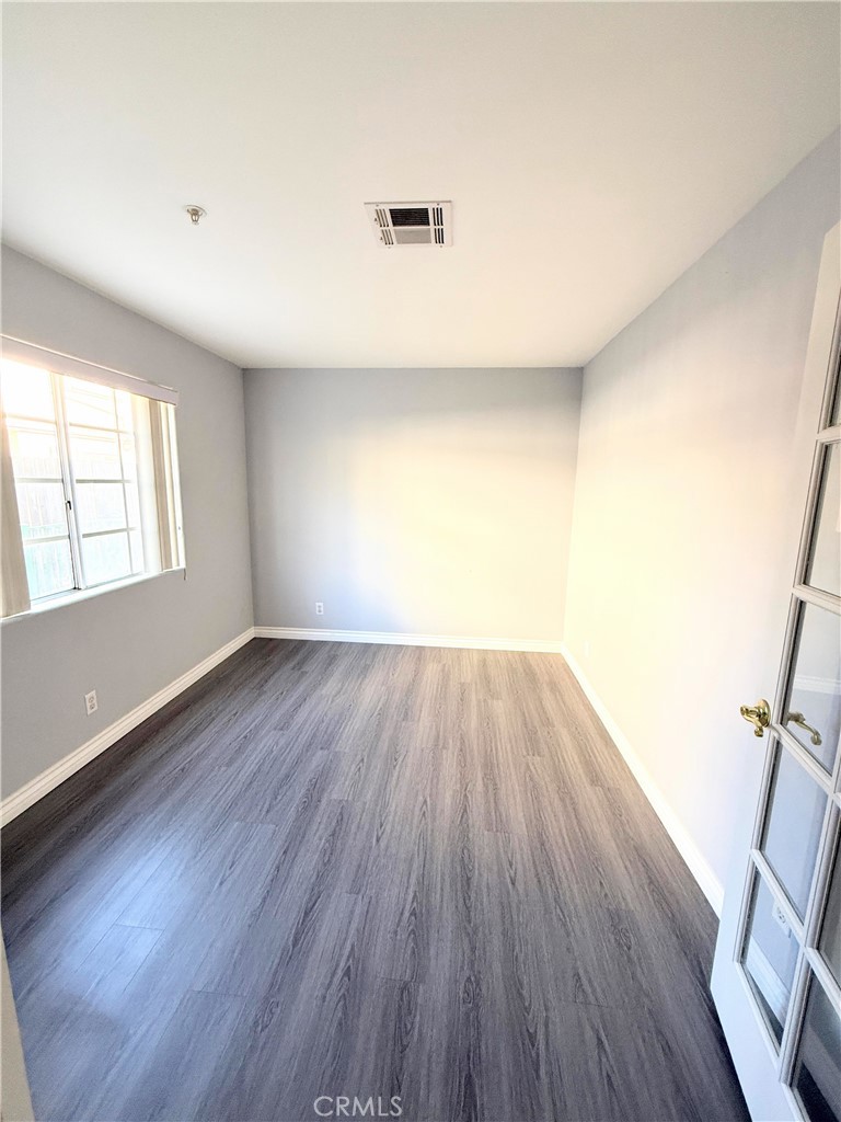 1230 Elm Avenue, Unit G San Gabriel, CA 91775 - Photo 14 of 33 an empty room with wooden floor and windows