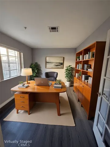 a view of empty room with wooden floor and fireplace