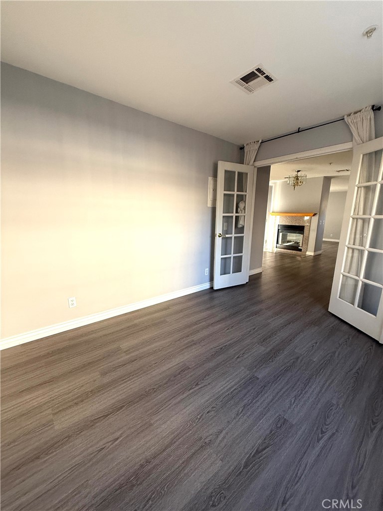 1230 Elm Avenue, Unit G San Gabriel, CA 91775 - Photo 16 of 33 a view of empty room with wooden floor and fireplace