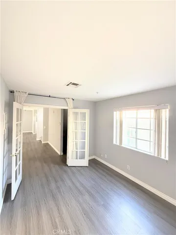 a view of a hallway with wooden cabinets