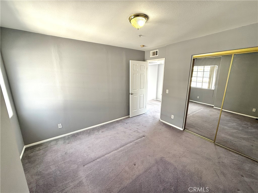 1230 Elm Avenue, Unit G San Gabriel, CA 91775 - Photo 23 of 33 an empty room with chandelier fan and windows