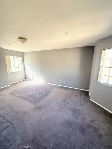 a bedroom with bed and window