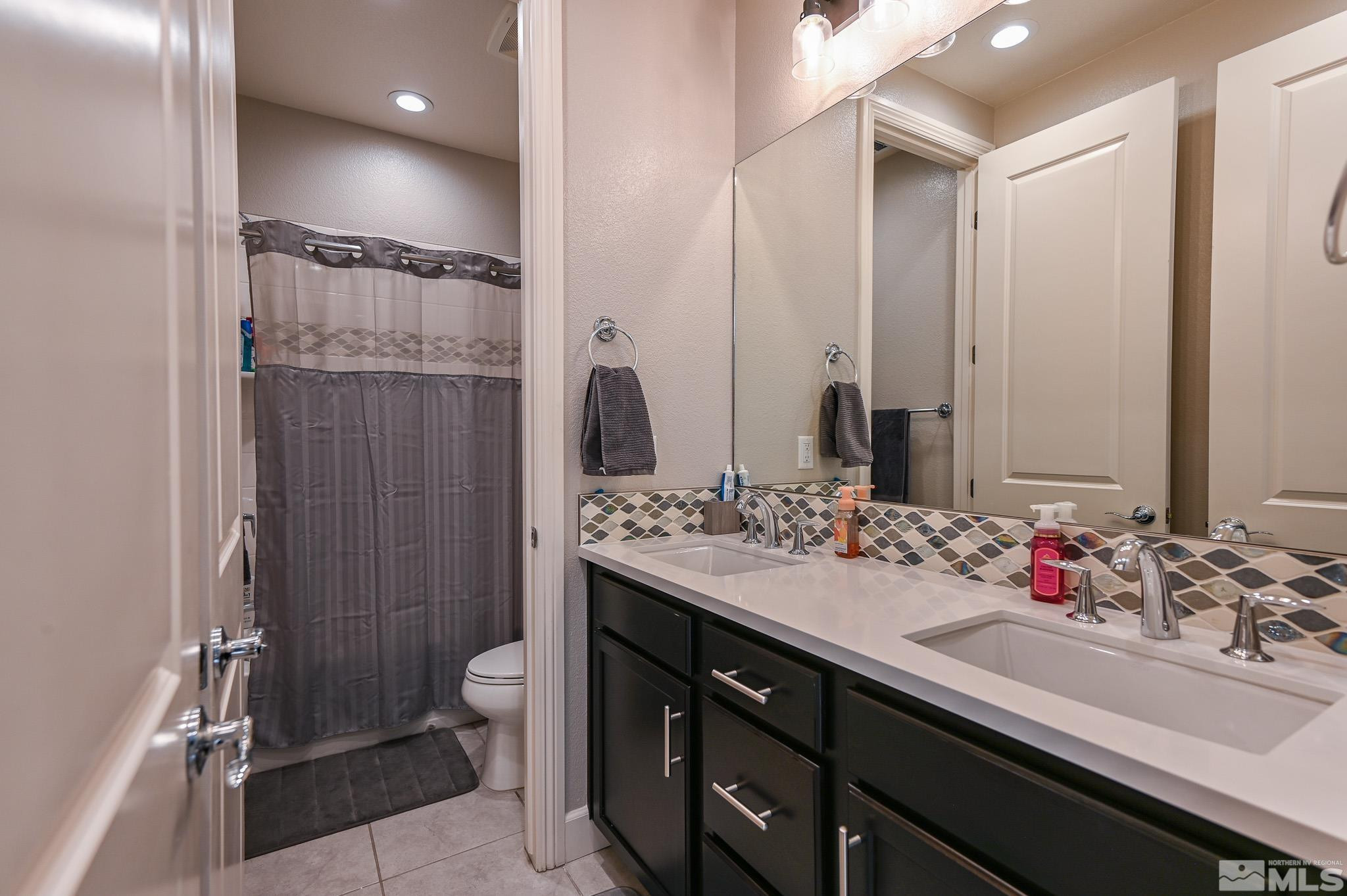 9330 Mayfair Way Reno, NV 89521 - Photo 23 of 40 a bathroom with a double vanity sink mirror double and shower