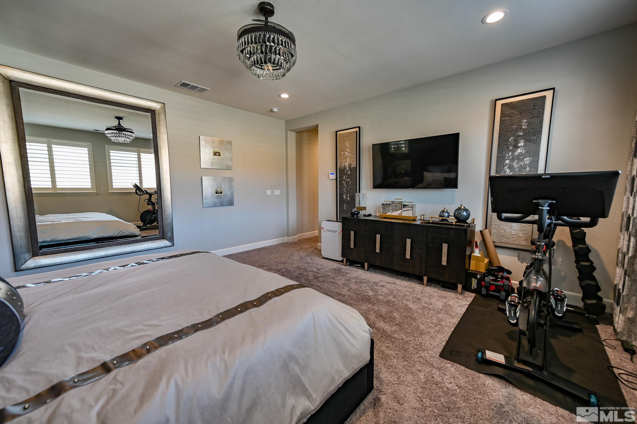 9330 Mayfair Way Reno, NV 89521 - Photo 30 of 40 a bedroom with a bed and a flat tv screen on the dresser