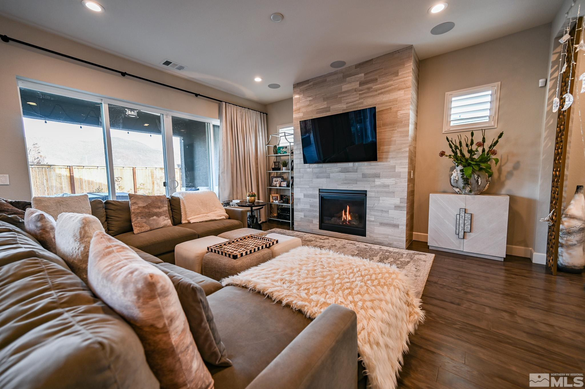 9330 Mayfair Way Reno, NV 89521 - Photo 3 of 40 a living room with furniture flat screen tv and a fireplace