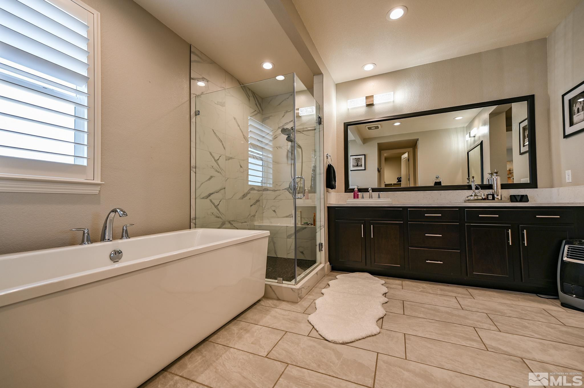 9330 Mayfair Way Reno, NV 89521 - Photo 31 of 40 a spacious bathroom with a sink vanity and a mirror
