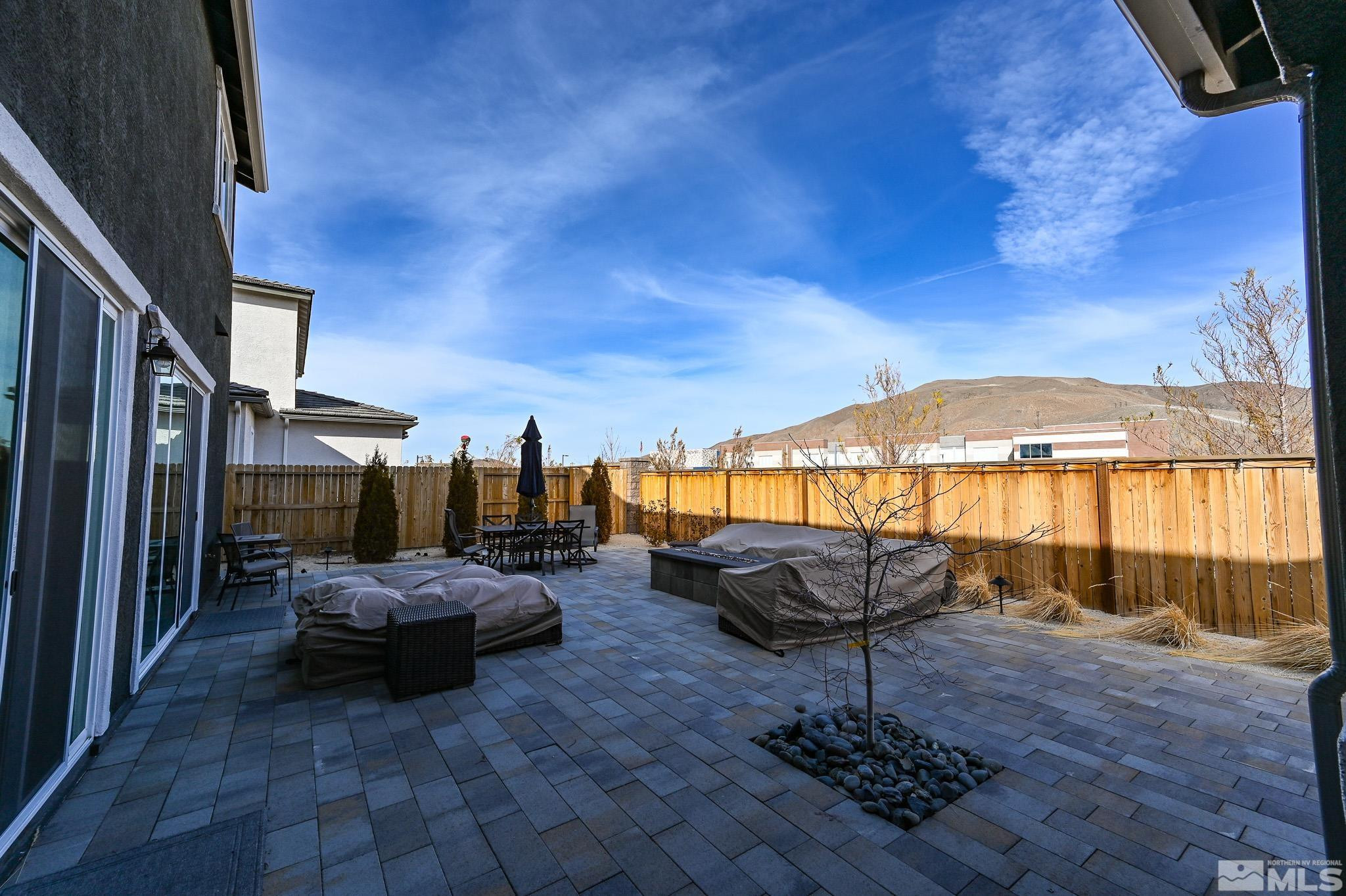 9330 Mayfair Way Reno, NV 89521 - Photo 40 of 40 a view of a patio with a table chairs and a fire pit