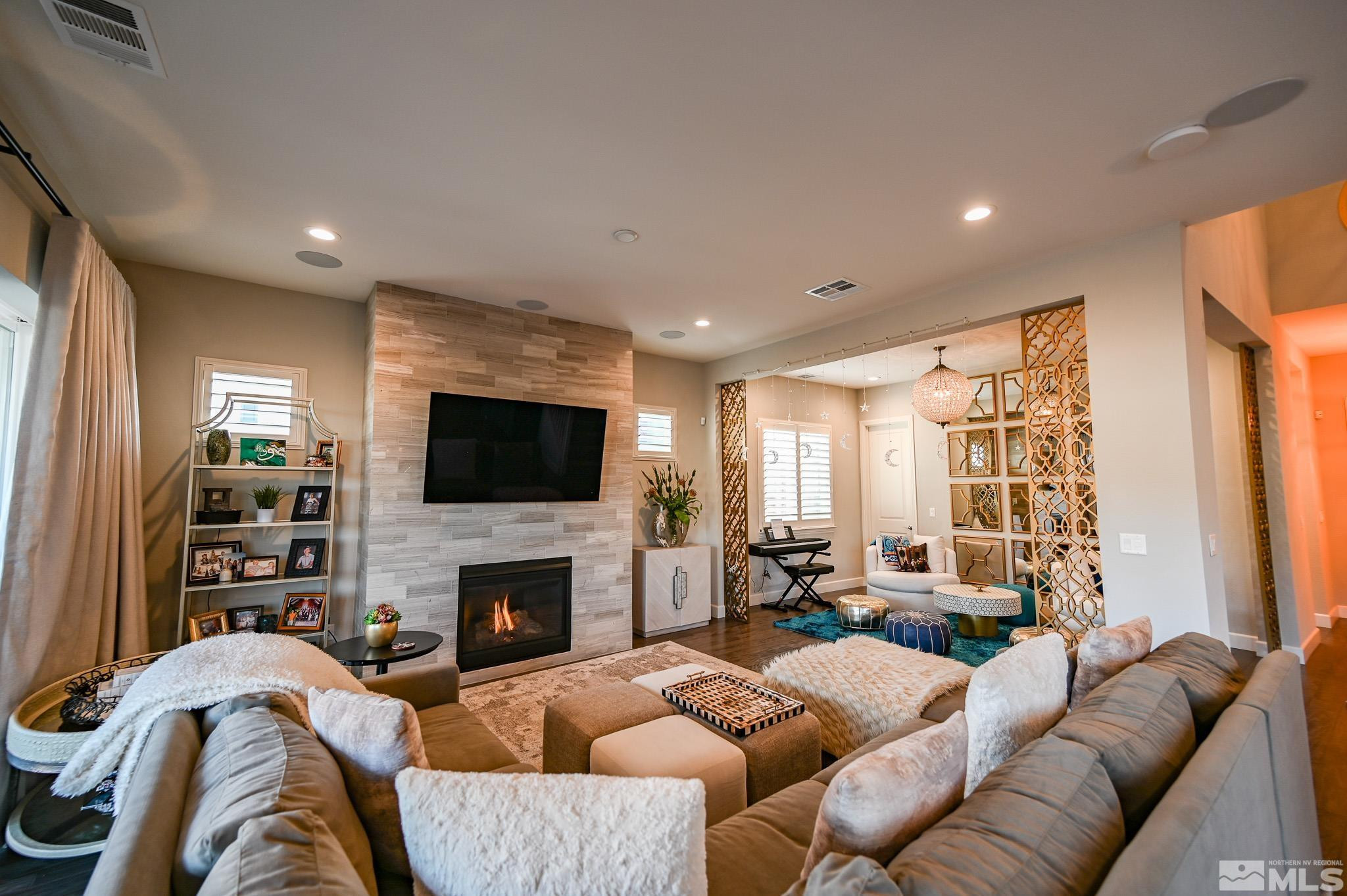 9330 Mayfair Way Reno, NV 89521 - Photo 4 of 40 a living room with furniture a flat screen tv and a fireplace