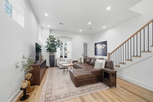 a living room with furniture and a potted plant