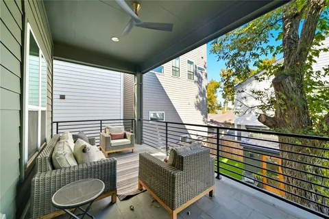 a balcony with furniture and a potted plant