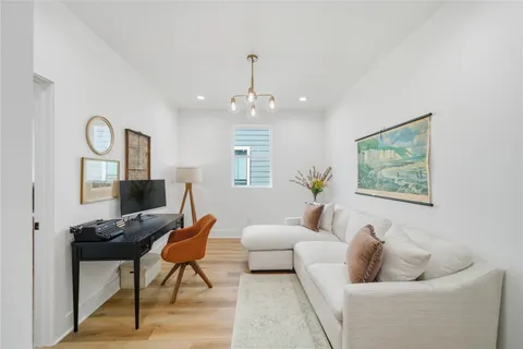 a living room with furniture and a chandelier