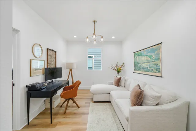 a living room with furniture and a chandelier