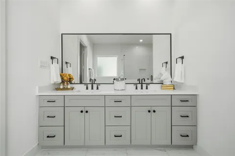 a bathroom with a double vanity sink double and a mirror