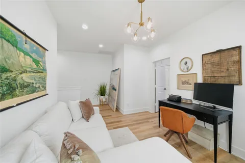a living room with furniture a window and a chandelier