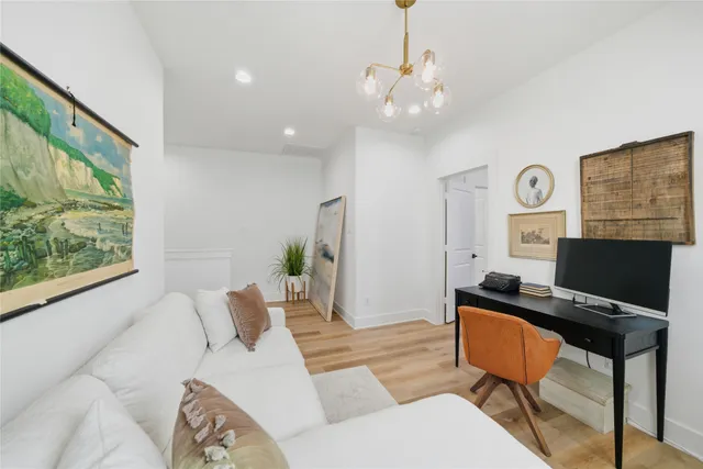 a living room with furniture a window and a chandelier