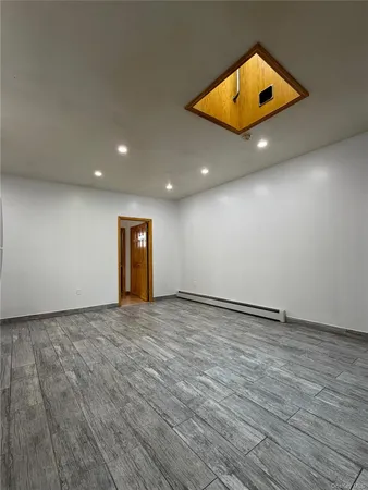an empty room with a window and a ceiling fan