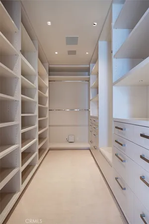 a hallway with a dining table wooden floor and a chandelier