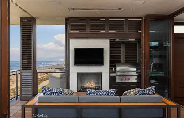 a living room with furniture and a floor to ceiling window