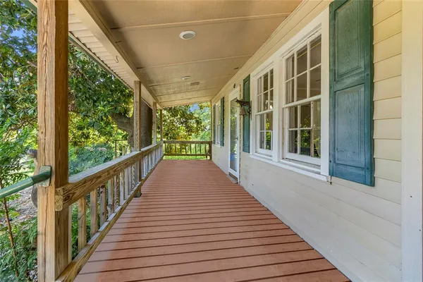 a view of a balcony with wooden floor